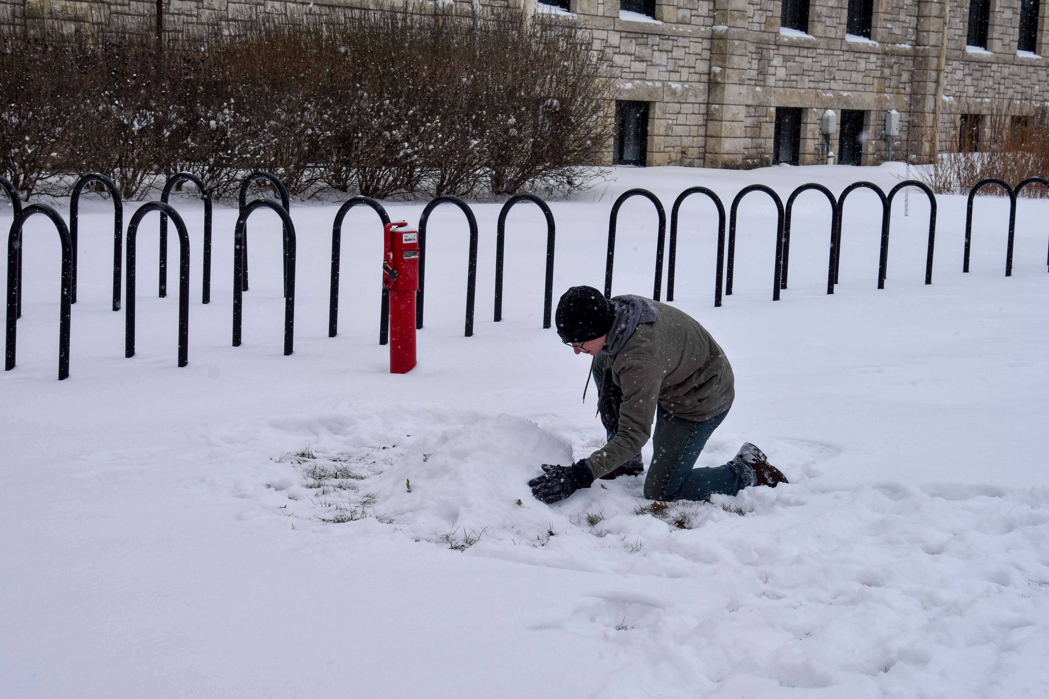 Student building a snowman