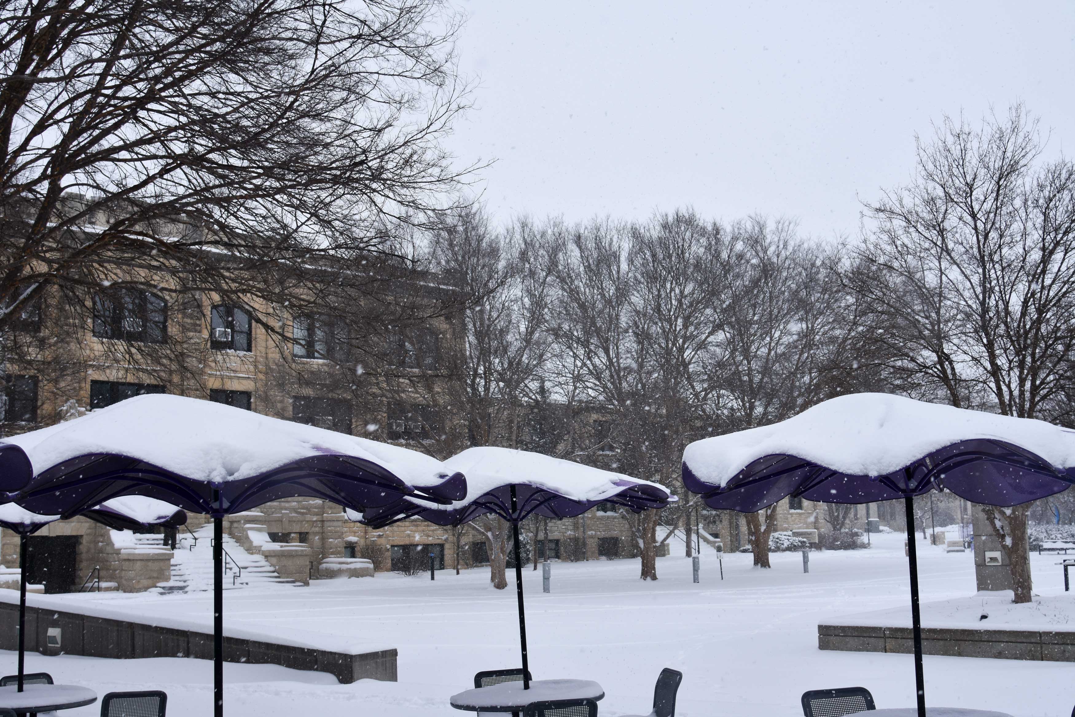 Snow gathered atop the umbrellas at Bosco Student Plaza. 