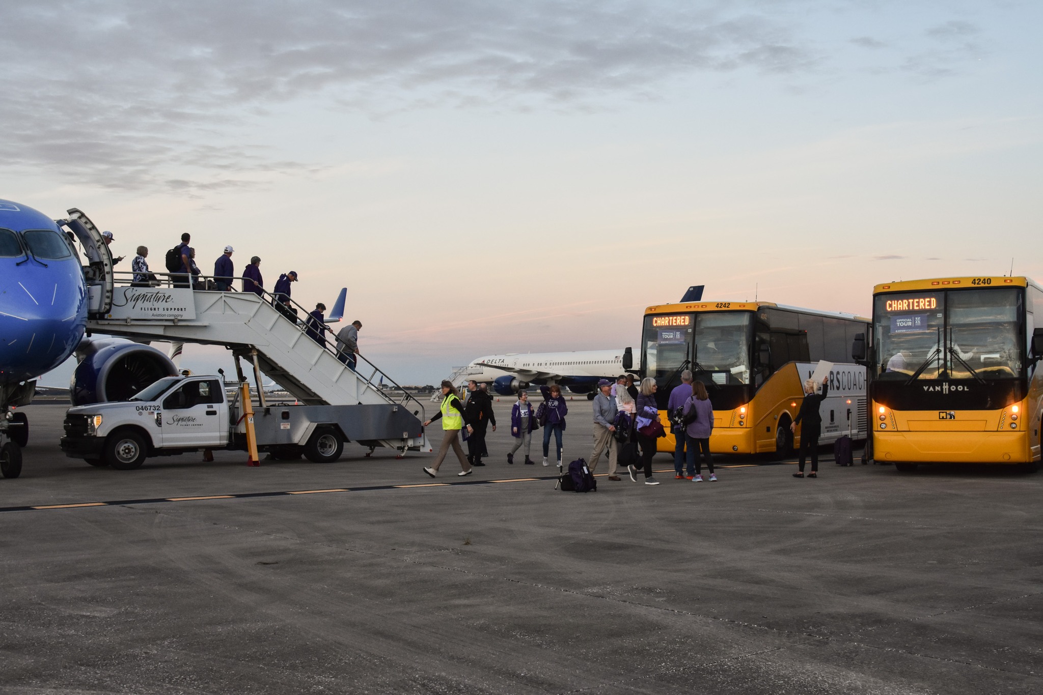 Travelers for the Pop-Tarts Bowl 2023 arrive at the Orlando, FL airport