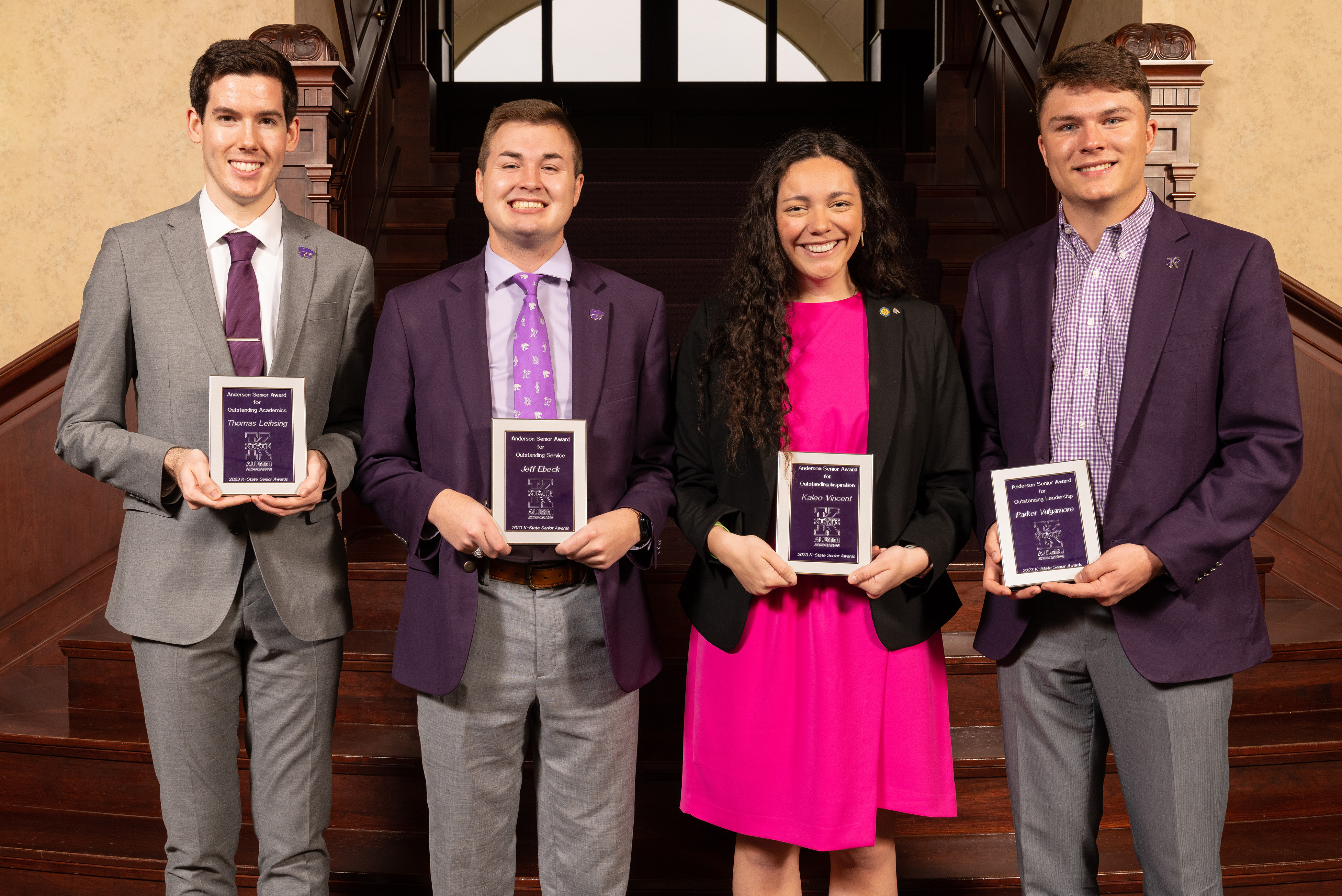 Anderson Award recipients group together with their plaques displayed