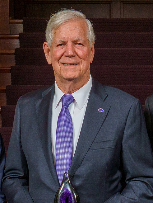 Richard Myers holding the Wildcat Pride Award for his portrait